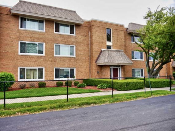 Front view of a three-story brick apartment building.