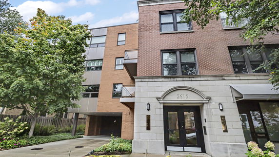 Front view of a multi-story brick and stone building.