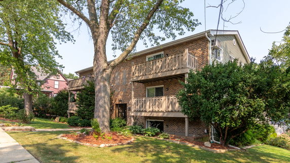 Front view of a two-story brick building with balconies.