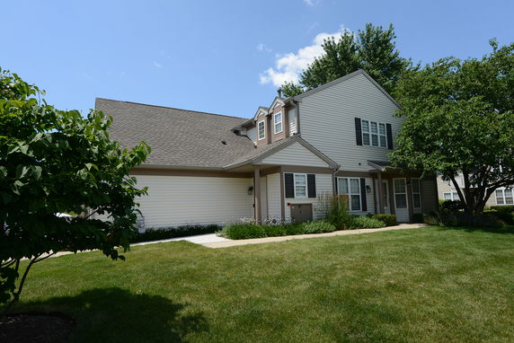 Front view of a two-story house with a gable roof and attached garage.