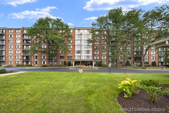 Front view of a multi-story apartment building with brick facade.