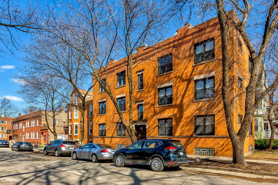 Front view of a three-story brick apartment building.