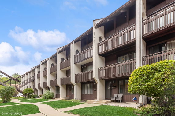 Front view of a multi-story residential building with balconies.