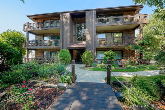Front view of a multi-story apartment building with balconies.