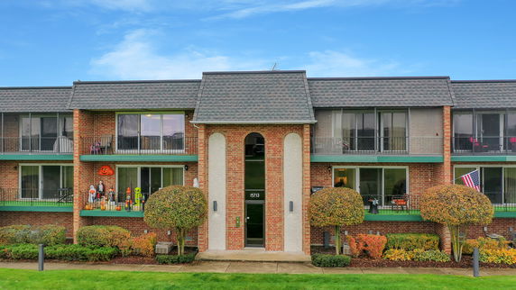 Front view of a two-story apartment building with balconies.
