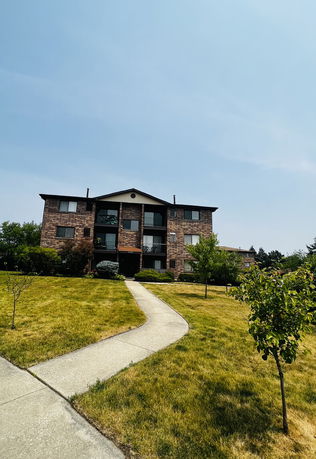 Front view of a three-story brick apartment building.