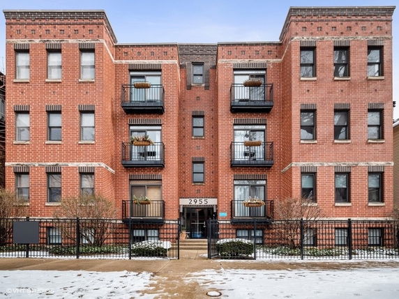 Front view of a multi-story brick apartment building.