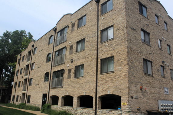 Front view of a multi-story brick apartment building.