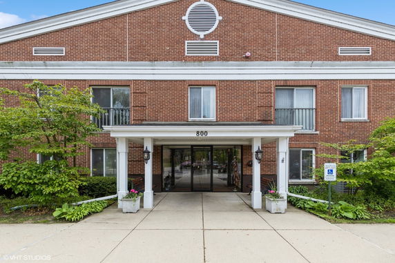 Front view of a brick building with a covered entrance.