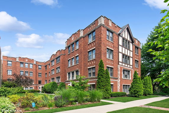 Front view of a multi-story brick apartment building.
