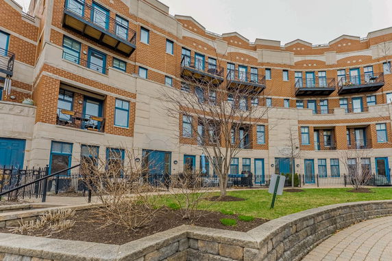 Front view of a multi-story apartment building with balconies.