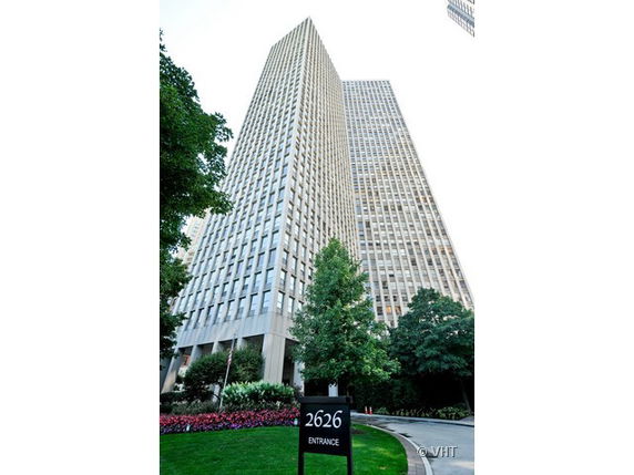 Front view of a high-rise building with glass windows.