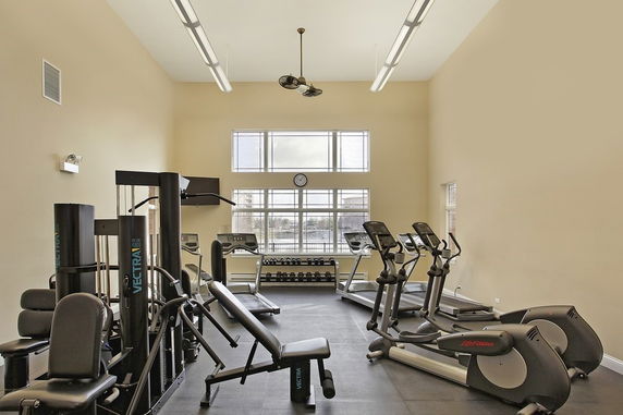 Indoor gym area with exercise equipment and windows