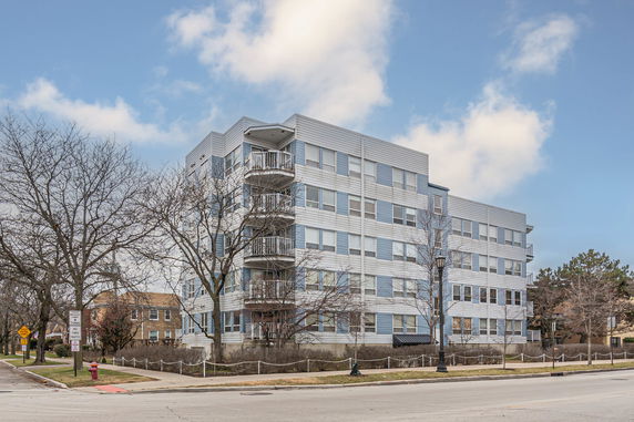 Front view of a multi-story residential building with balconies
