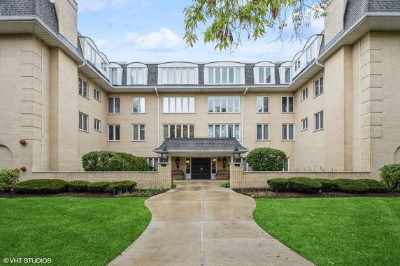 Front view of a multi-story building with a central entrance.