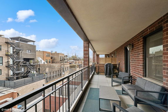 Balcony view overlooking neighboring buildings in an urban area.