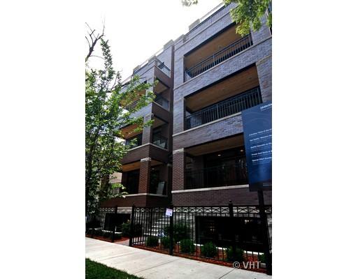 Front view of a multi-story brick building with balconies.