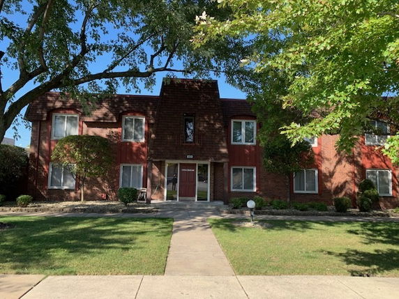 Front view of a two-story brick apartment building.