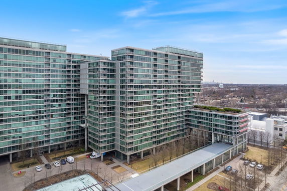 Front view of a large multi-story building with extensive glass windows.