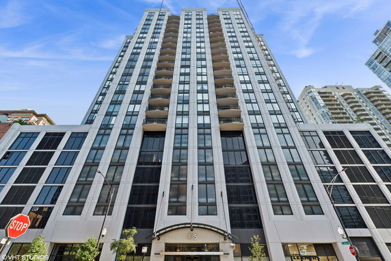 Front view of a tall multi-story building with multiple balconies.
