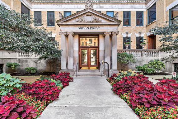 Front view of a building with a decorative entrance and landscaping.