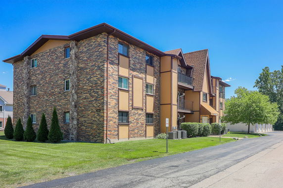 Front view of a multi-story building with brick and panel facade.