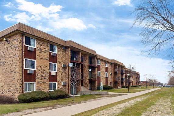 Front view of a three-story brick apartment building.