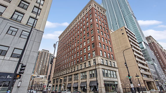 Front view of a multi-story brick building in an urban area.