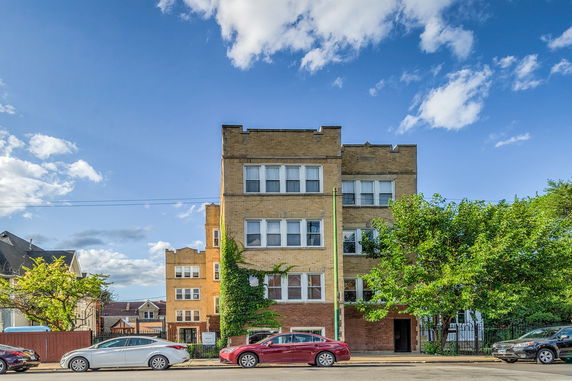 Front view of a multi-story brick apartment building.