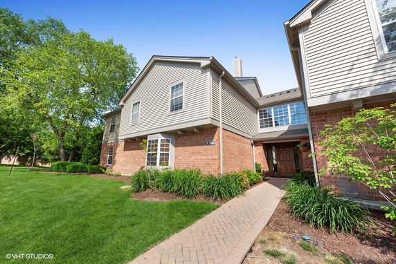 Front view of a two-story house with brick and siding exterior.