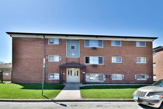Front view of a multi-story brick building.