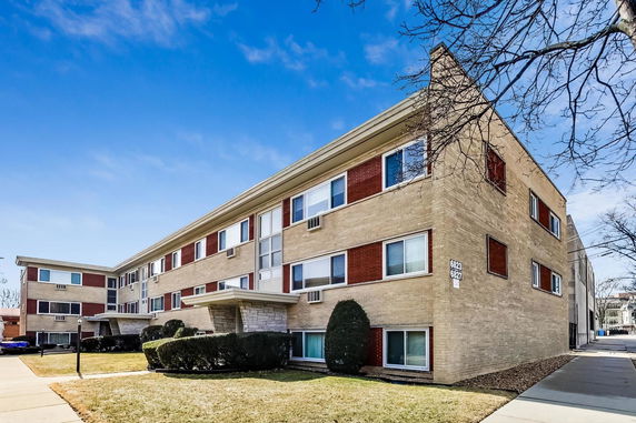 Front view of a three-story brick apartment building.