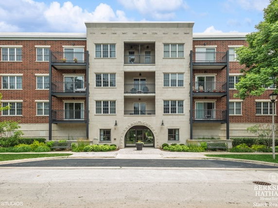 Front view of a multi-story building with brick and stone facade.