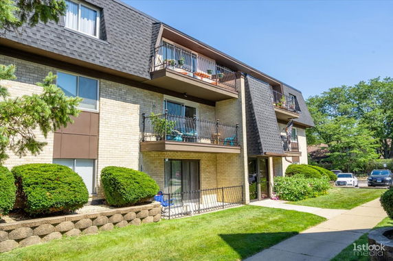 Front view of a multi-story residential building with balconies.