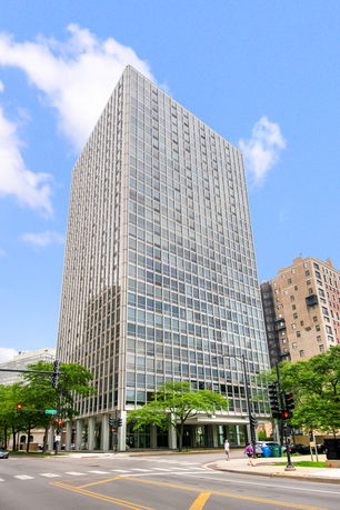 Front view of a tall glass-covered office building.