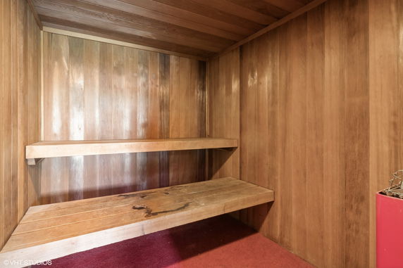 Interior view of a wooden sauna room with benches.