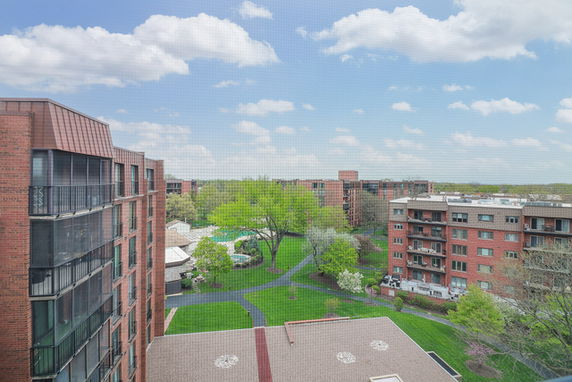 Panoramic view of multiple residential buildings and surrounding greenery.