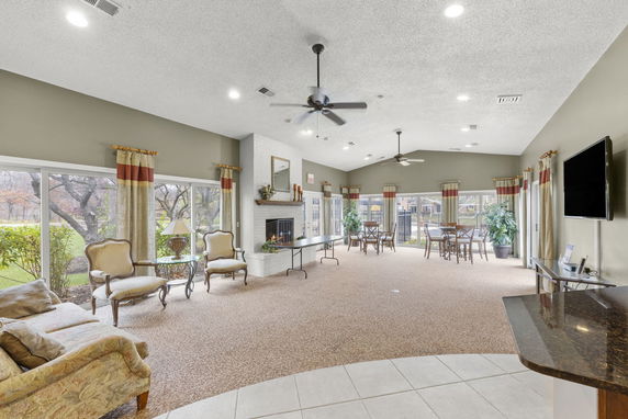Indoor clubhouse area with seating and large windows.