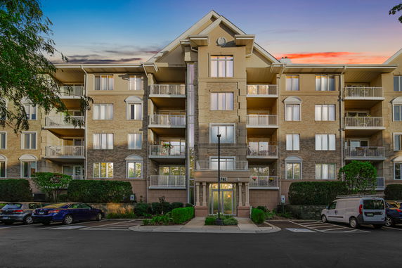 Front view of a multi-story residential building with balconies.
