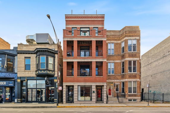 Front view of a multi-story brick building in an urban setting.