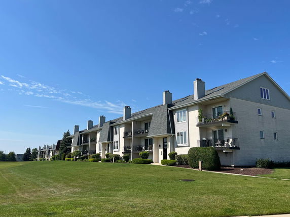 Front view of a multi-story residential building with balconies.
