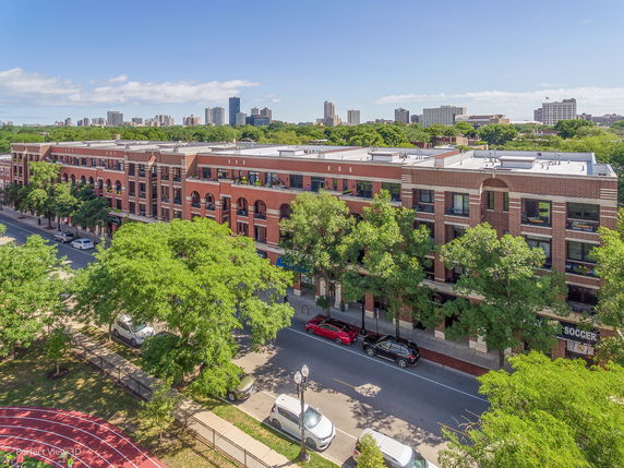 Aerial view of a multi-story brick building in an urban setting.