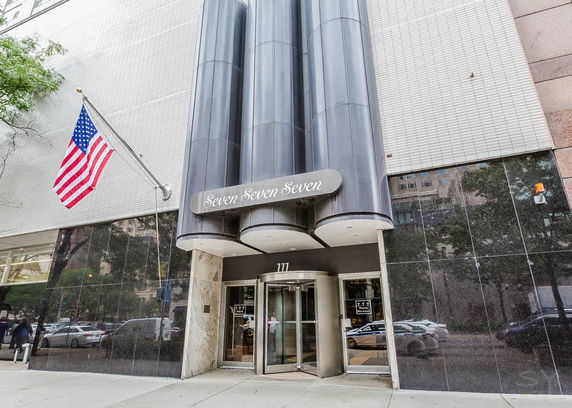 Front view of a modern building entrance with a revolving door.