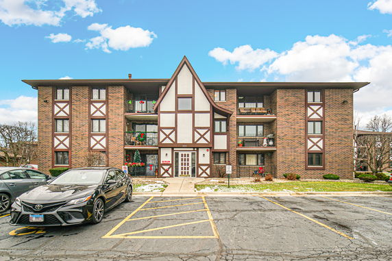 Front view of a three-story brick apartment building.