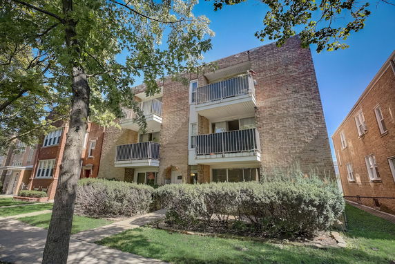 Front view of a multi-story building with balconies.