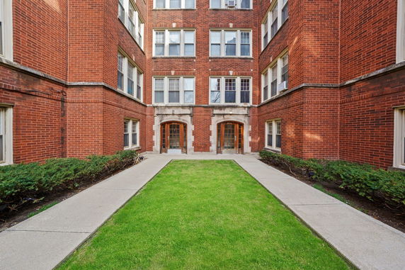 Front view of a multi-story brick building with two main entrances.