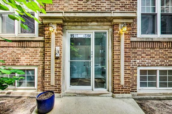 Front view of a brick building with a glass door entrance.