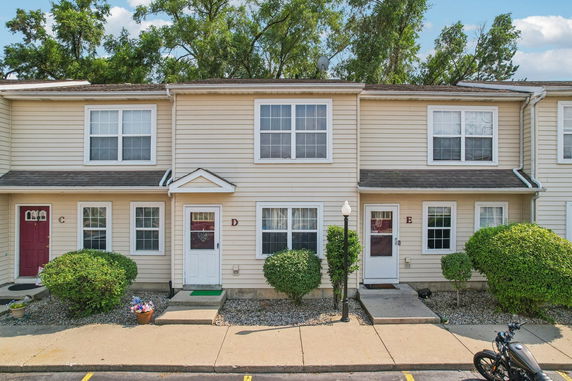 Front view of a two-story townhouse with multiple entrances.