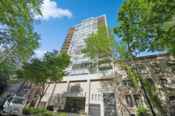 Front view of a multi-story building with large windows and balconies.