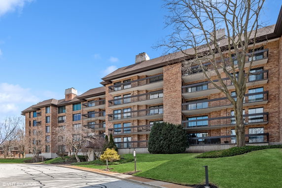 Front view of a multi-story residential building with balconies.